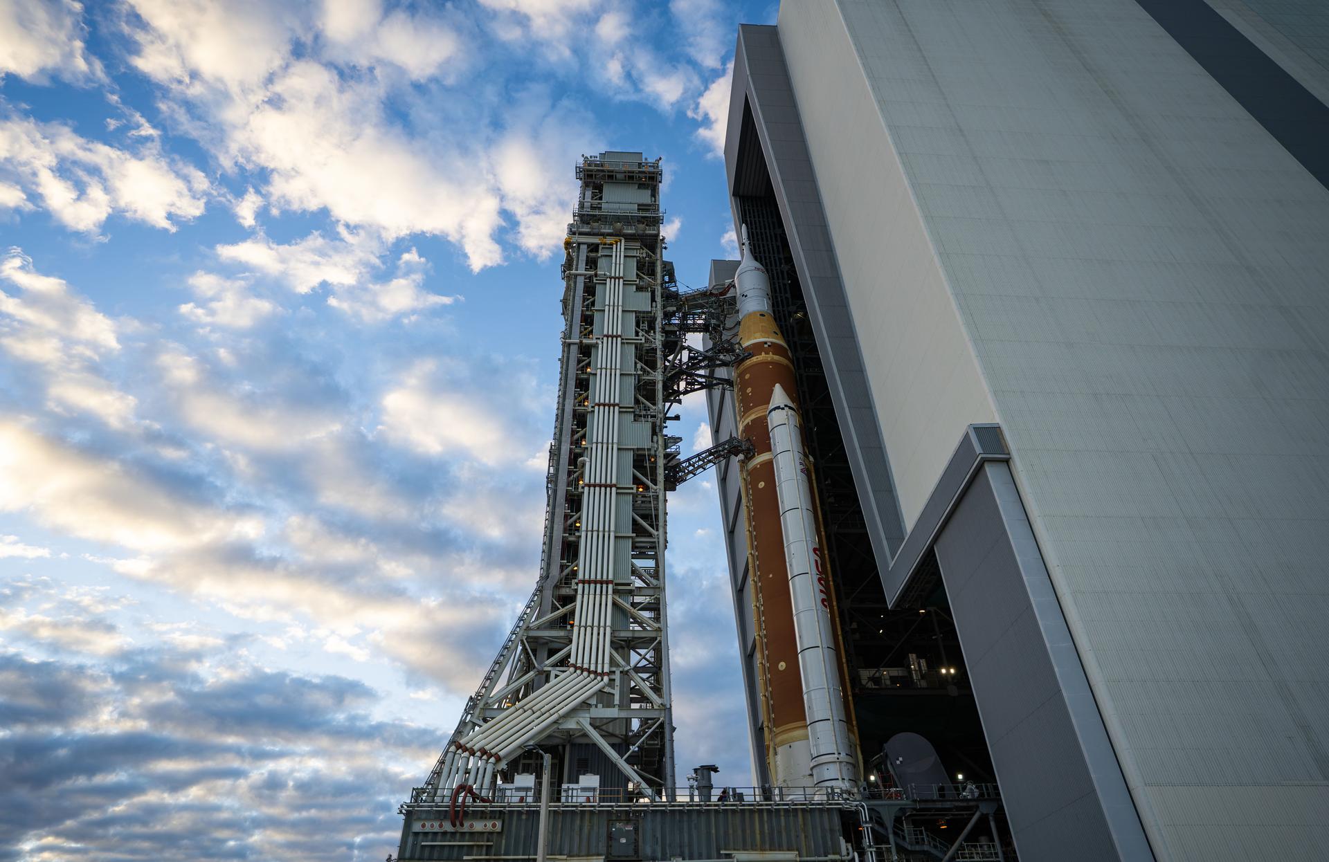 This image shows NASA’s SLS (Space Launch System) and Orion spacecraft rolling out of the Vehicle Assembly Building at NASA’s Kennedy Space Center. NASA's massive Crawler-Transporter, upgraded for the Artemis program, carries the powerful SLS rocket and Orion spacecraft on the Mobile Launcher from the Vehicle Assembly Building to Launch Pad 39B at Kennedy Space Center   in preparation for the Artemis II mission.